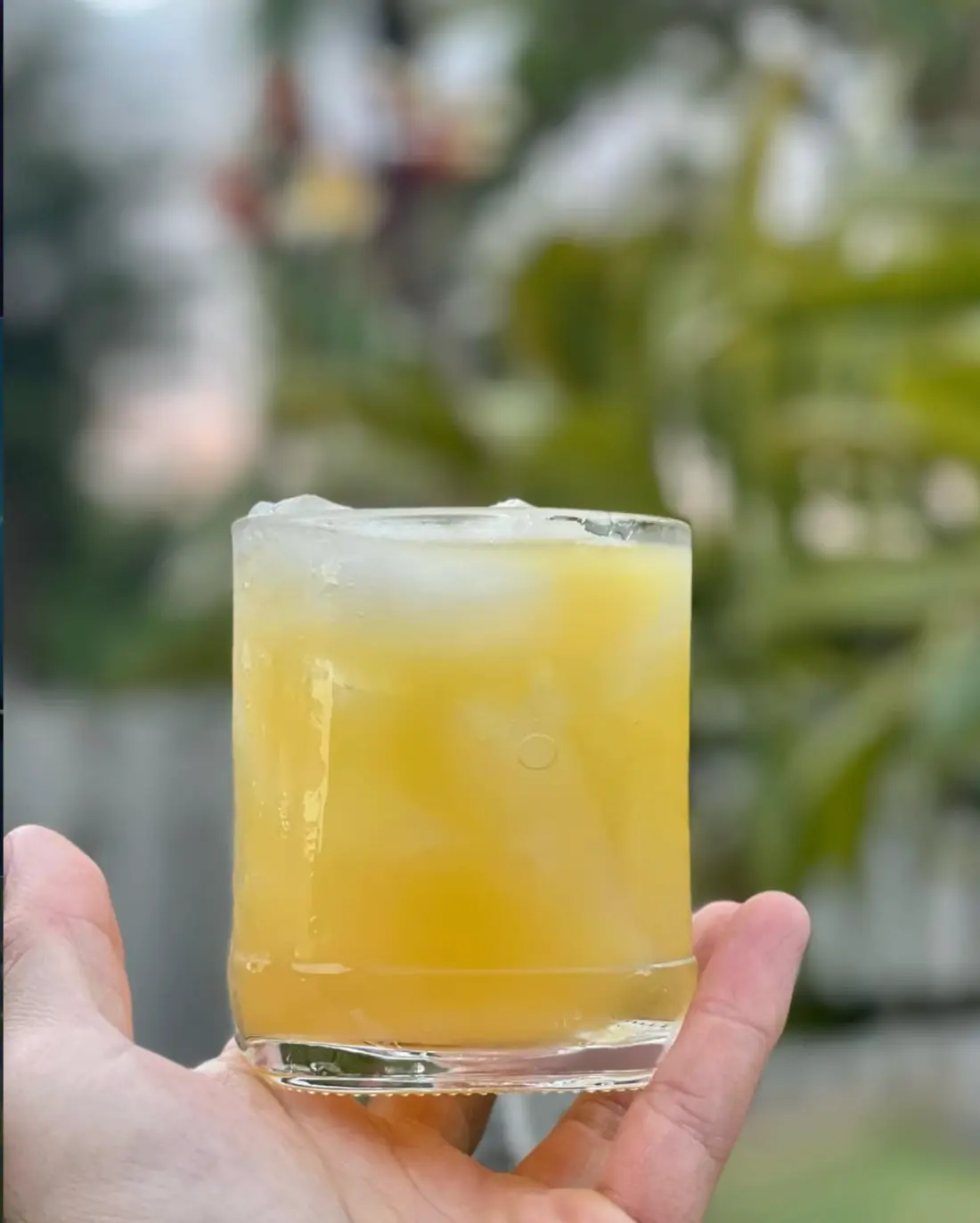 Golden cocktail served over ice in a short glass